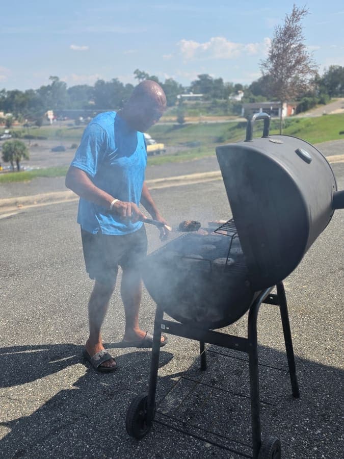 Volunteer grilling food for Enrollment Day guests