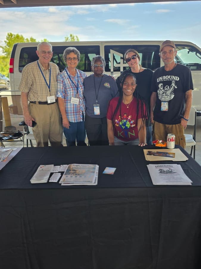 Community partners gathered behind an information table